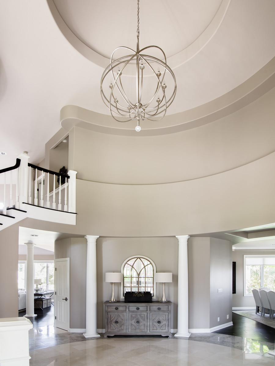 Example of a mid-sized transitional marble floor and gray floor foyer design in Seattle with gray walls and a dark wood front door