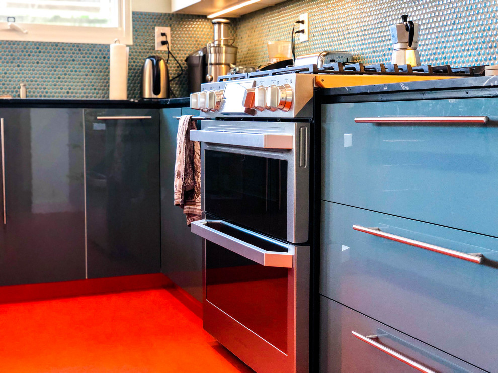 Inredning av ett modernt mellanstort svart svart kök, med en nedsänkt diskho, släta luckor, blå skåp, bänkskiva i kvartsit, blått stänkskydd, stänkskydd i keramik, rostfria vitvaror, vinylgolv och orange golv