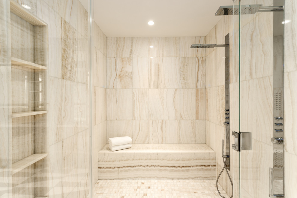 This is an example of an expansive contemporary master bathroom in Vancouver with beaded inset cabinets, a drop-in tub, a corner shower, a one-piece toilet, multi-coloured tile, mosaic tile, multi-coloured walls, marble floors, a drop-in sink, onyx benchtops and medium wood cabinets.