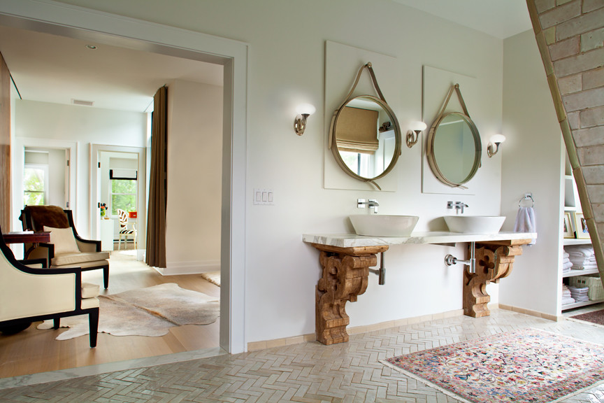 This is an example of a traditional master bathroom in New York with a one-piece toilet, a vessel sink, white walls, an open shower, subway tile, open cabinets, light wood cabinets, marble benchtops, white tile and terra-cotta floors.