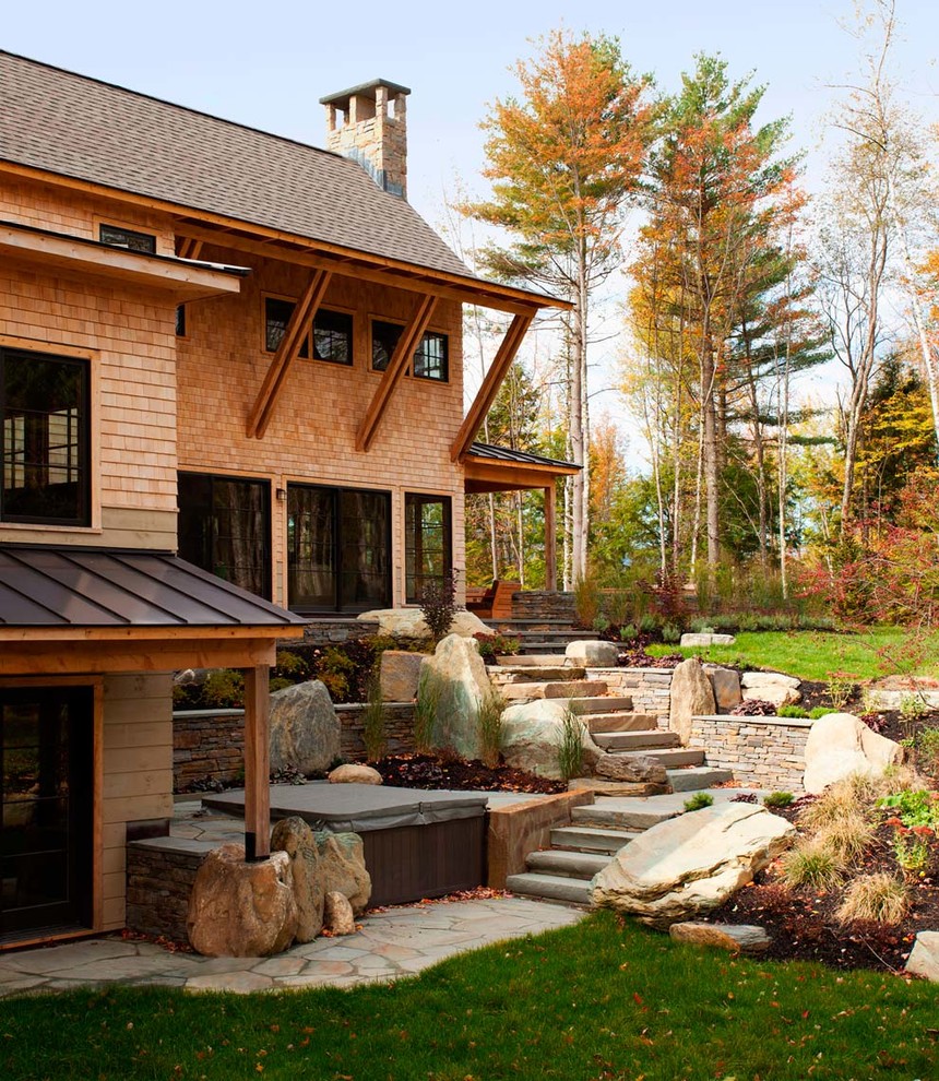 Design ideas for a contemporary sloped garden in Burlington with natural stone pavers.