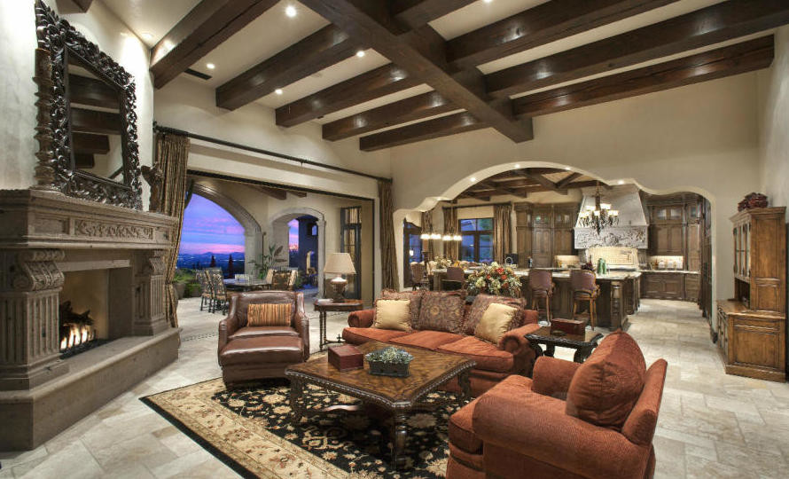 Photo of an expansive mediterranean formal open concept living room in Phoenix with beige walls, a two-sided fireplace, a stone fireplace surround, no tv, multi-coloured floor and travertine floors.