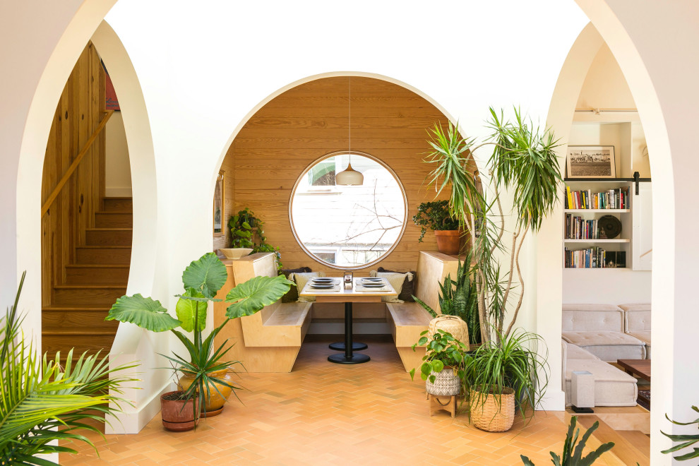 Entryway - contemporary terra-cotta tile, vaulted ceiling and shiplap wall entryway idea in Other with white walls and a medium wood front door