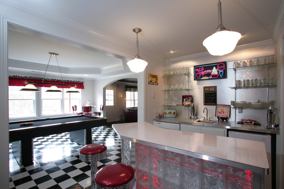 Mid-sized eclectic galley seated home bar in Atlanta with vinyl floors, multi-coloured floor, a drop-in sink, glass-front cabinets, terrazzo benchtops and metal splashback.
