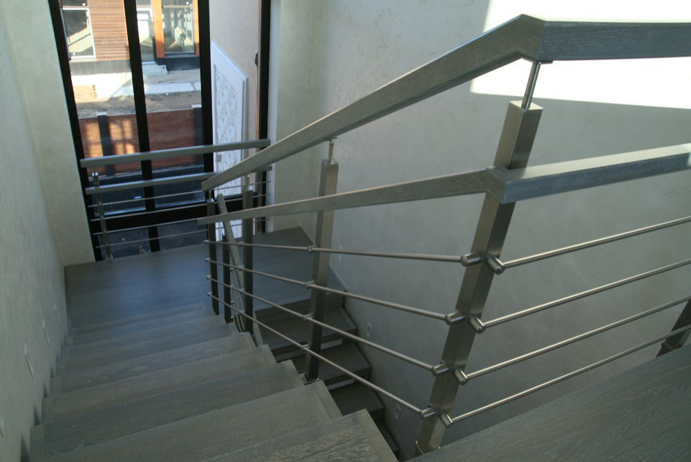 Modern metal stair covered by patina oak