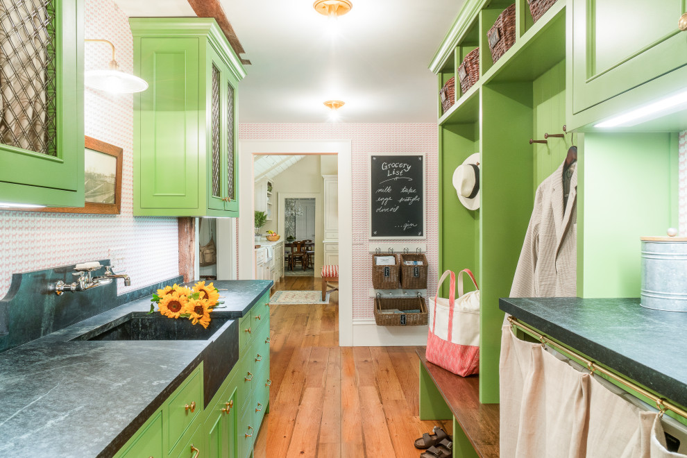 Inspiration for a transitional laundry room in Boston with an integrated sink, recessed-panel cabinets, green cabinets, soapstone benchtops and black benchtop.