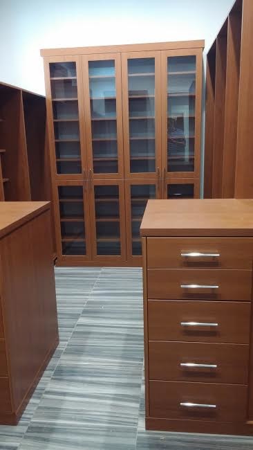 Example of a mid-sized minimalist men's slate floor and gray floor walk-in closet design in Tampa with flat-panel cabinets and brown cabinets