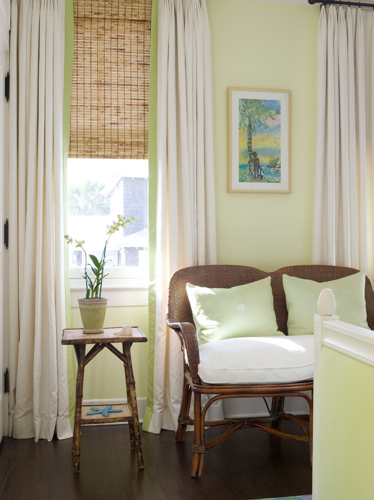 This is an example of a large beach style master bedroom in Jacksonville with green walls and dark hardwood floors.