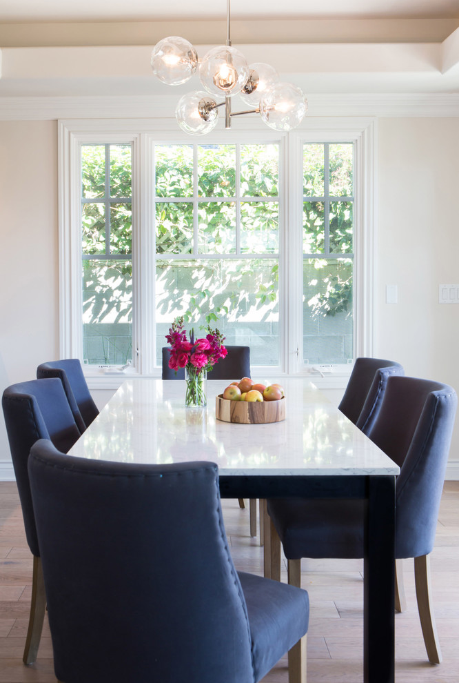 This is an example of a mid-sized transitional separate dining room in Los Angeles with white walls, light hardwood floors, no fireplace and brown floor.