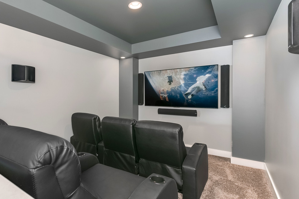 This is an example of an expansive contemporary home theatre in Minneapolis with grey walls, carpet and brown floor.