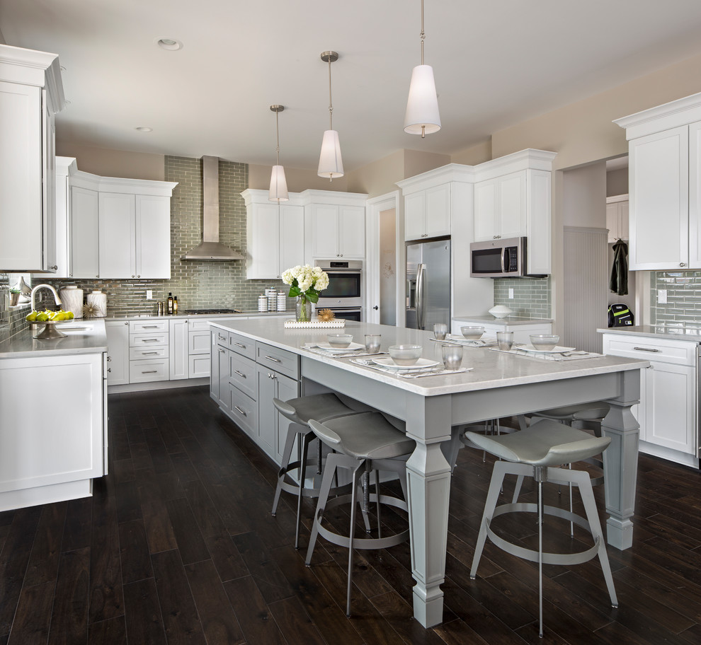 Inspiration for a large transitional galley separate kitchen in Other with a double-bowl sink, recessed-panel cabinets, grey cabinets, grey splashback, stainless steel appliances, dark hardwood floors, with island and brown floor.