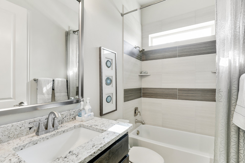 Mid-sized traditional kids bathroom in Dallas with recessed-panel cabinets, dark wood cabinets, an alcove tub, a shower/bathtub combo, beige tile, ceramic tile, beige walls, ceramic floors, an undermount sink, granite benchtops, beige floor, a shower curtain and grey benchtops.