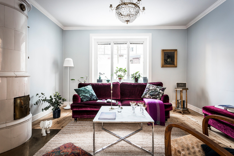 Inspiration for a mid-sized scandinavian formal living room in Stockholm with blue walls, light hardwood floors and no tv.