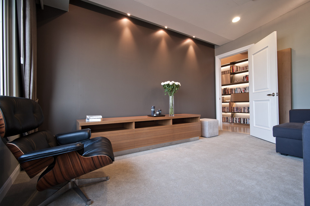 This is an example of a contemporary enclosed family room in Other with carpet and grey walls.
