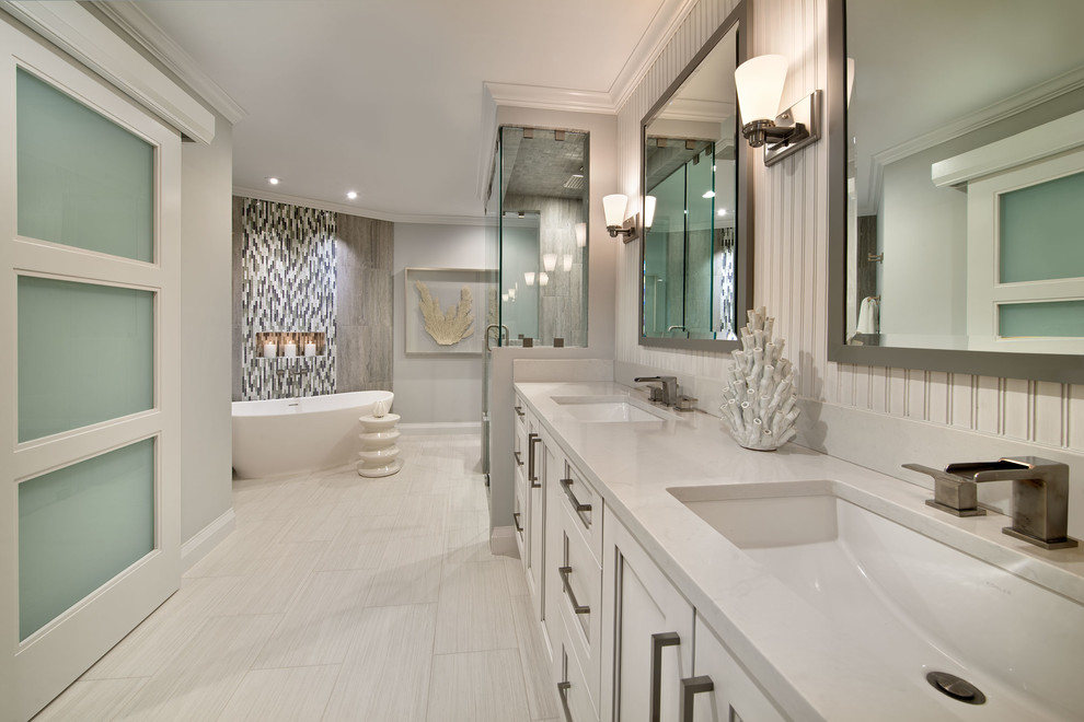 Design ideas for a large contemporary master bathroom in Miami with a freestanding tub, a two-piece toilet, an undermount sink, recessed-panel cabinets, a curbless shower, white cabinets, porcelain tile, white walls, porcelain floors and quartzite benchtops.