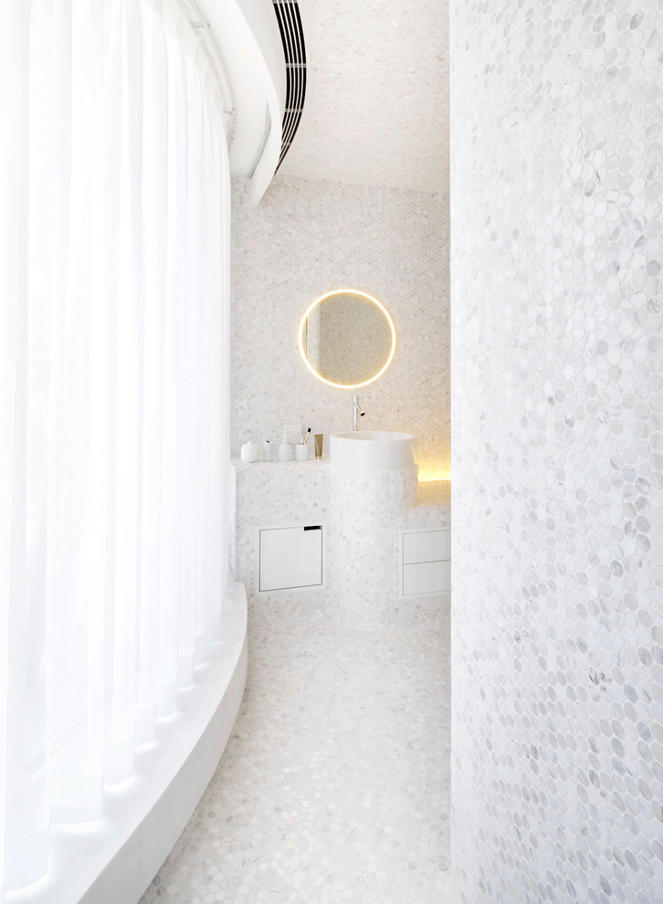 Photo of a large contemporary master bathroom in Other with flat-panel cabinets, white cabinets, a shower/bathtub combo, white tile, white walls, marble floors and tile benchtops.