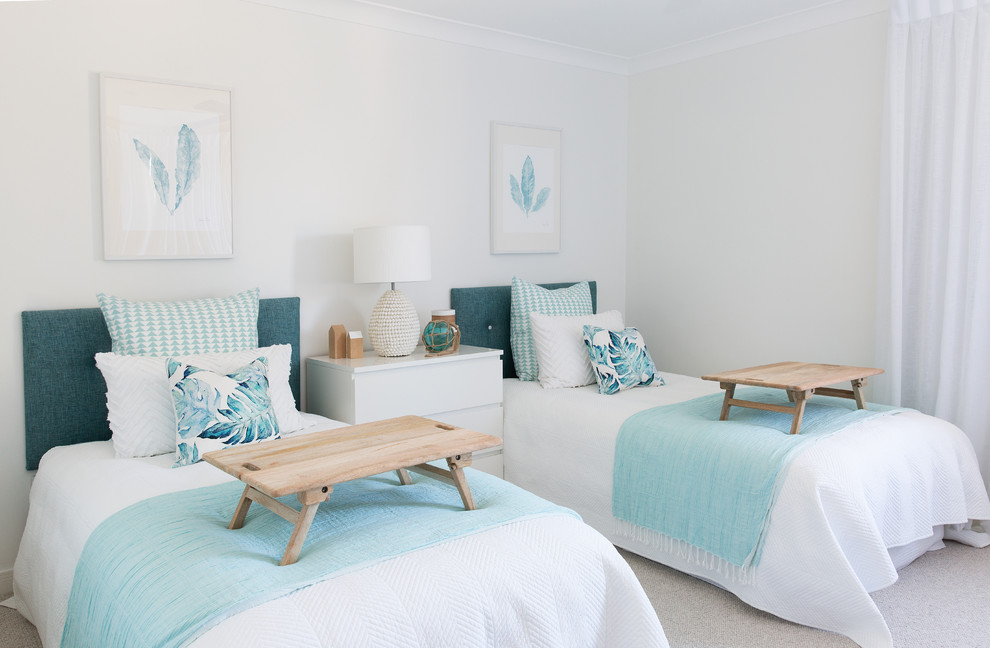 Design ideas for a mid-sized beach style guest bedroom in Gold Coast - Tweed with white walls, carpet and grey floor.