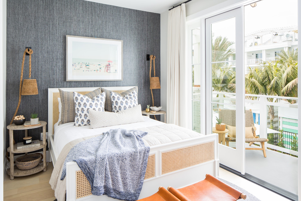 Design ideas for a beach style bedroom in Orange County with grey walls, light hardwood floors and beige floor.