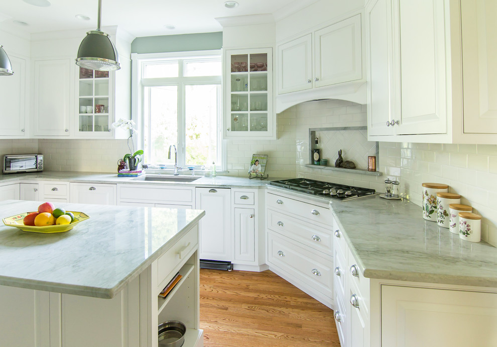 Mid-sized traditional u-shaped separate kitchen in Philadelphia with an undermount sink, beaded inset cabinets, white cabinets, quartzite benchtops, white splashback, ceramic splashback, stainless steel appliances, medium hardwood floors, with island, beige floor and green benchtop.