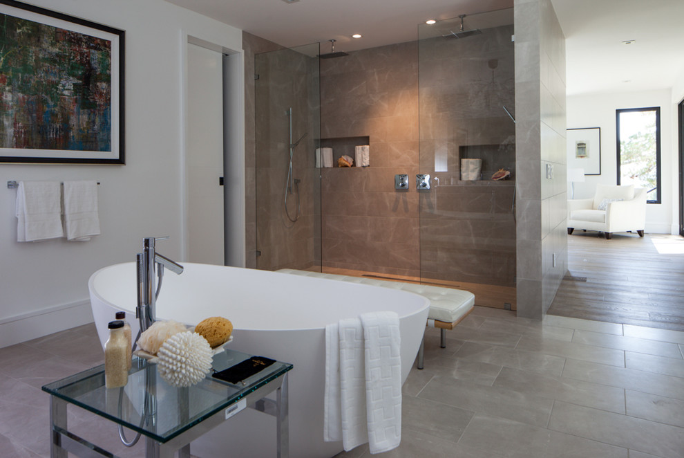 Photo of a large contemporary master bathroom in San Francisco with a freestanding tub, an alcove shower and beige tile.