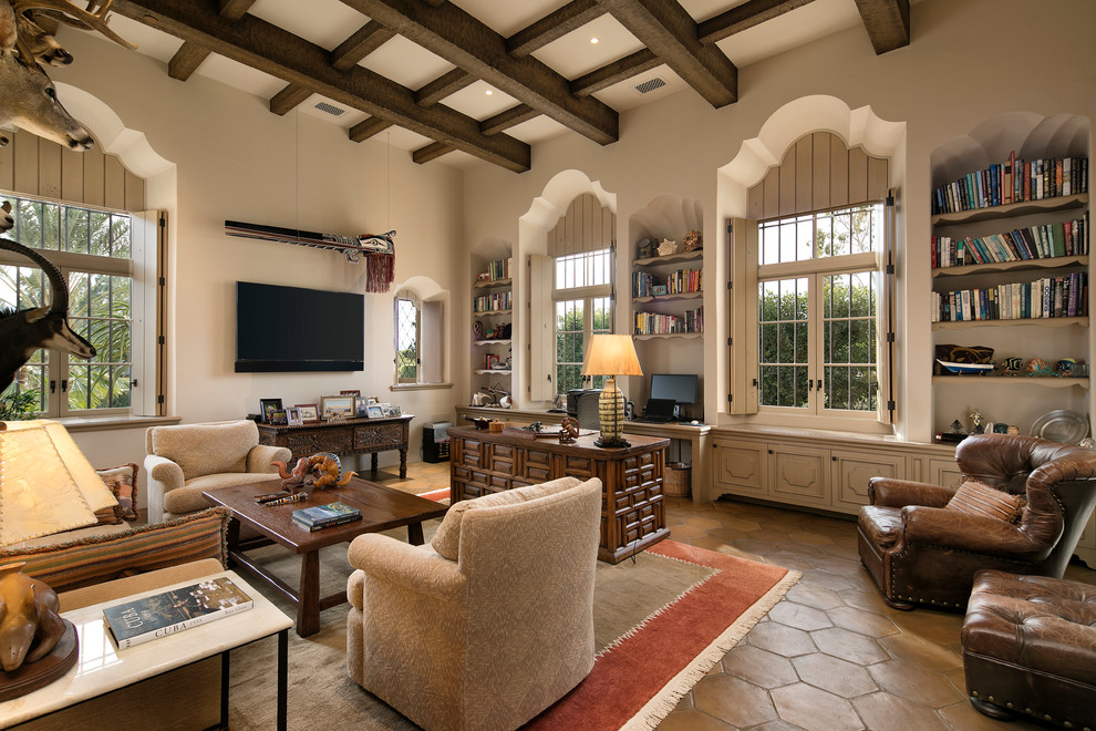 Inspiration for a large mediterranean study room in Santa Barbara with beige walls, terra-cotta floors, no fireplace and a freestanding desk.