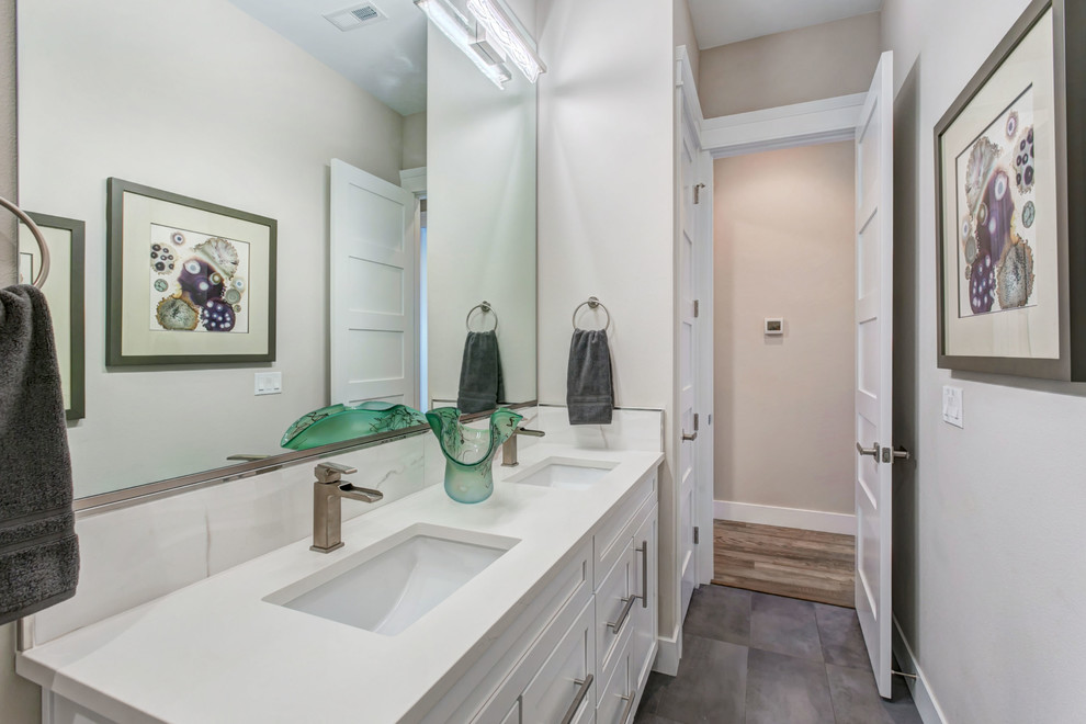 Design ideas for a mid-sized transitional bathroom in Seattle with shaker cabinets, white cabinets, an alcove tub, a shower/bathtub combo, a two-piece toilet, white tile, porcelain tile, an undermount sink, engineered quartz benchtops, a shower curtain and white benchtops.