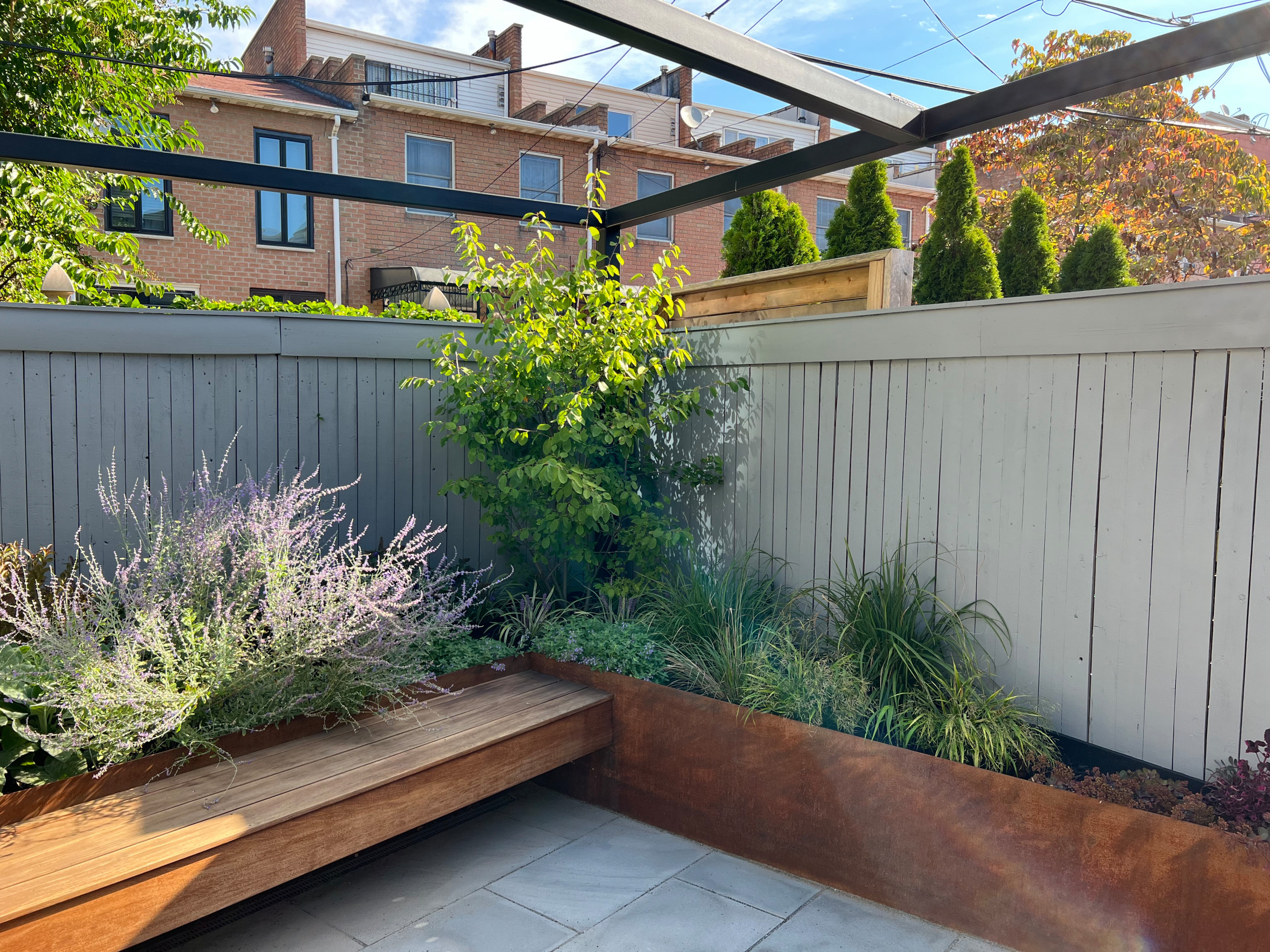 Paved patio with metal grating garden