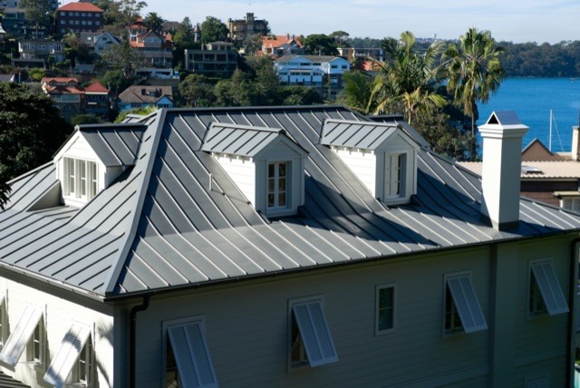 This is an example of a contemporary house exterior in Other with a gable roof and a metal roof.