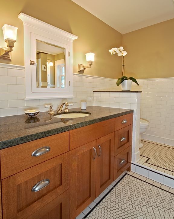 Design ideas for a small arts and crafts 3/4 bathroom in Seattle with shaker cabinets, medium wood cabinets, white tile, subway tile, beige walls, ceramic floors, an undermount sink, granite benchtops, white floor and black benchtops.