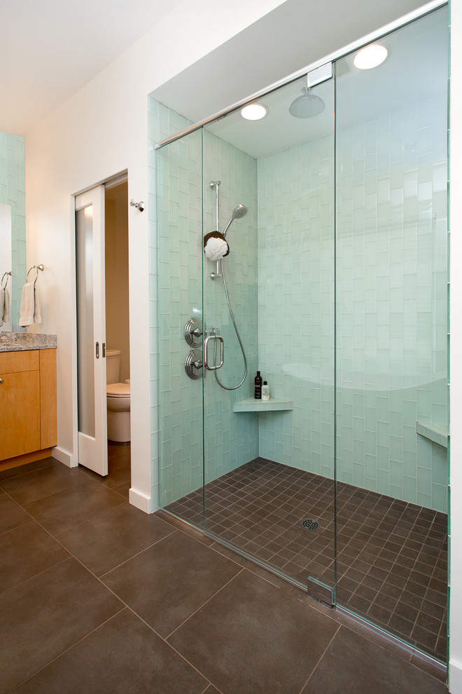 Design ideas for a large modern master bathroom in Seattle with flat-panel cabinets, medium wood cabinets, a freestanding tub, an alcove shower, a one-piece toilet, green tile, glass tile, white walls, ceramic floors, an undermount sink and granite benchtops.