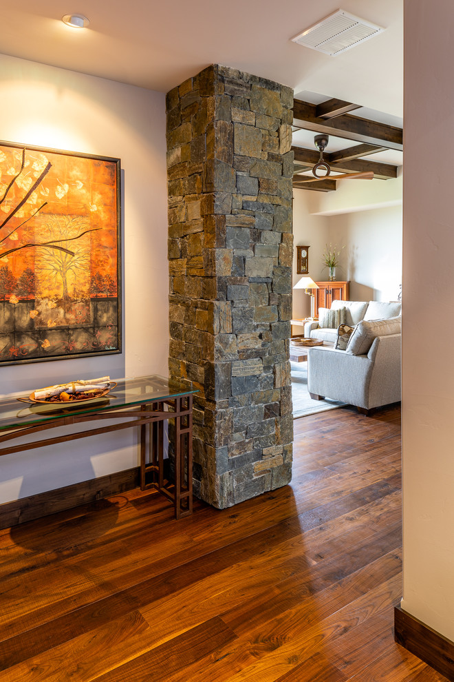 Example of a mid-sized mountain style dark wood floor and brown floor hallway design with beige walls