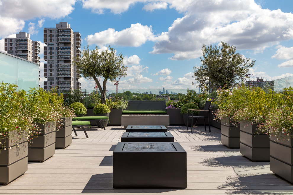 Mid-sized contemporary rooftop deck in London with a water feature and no cover.