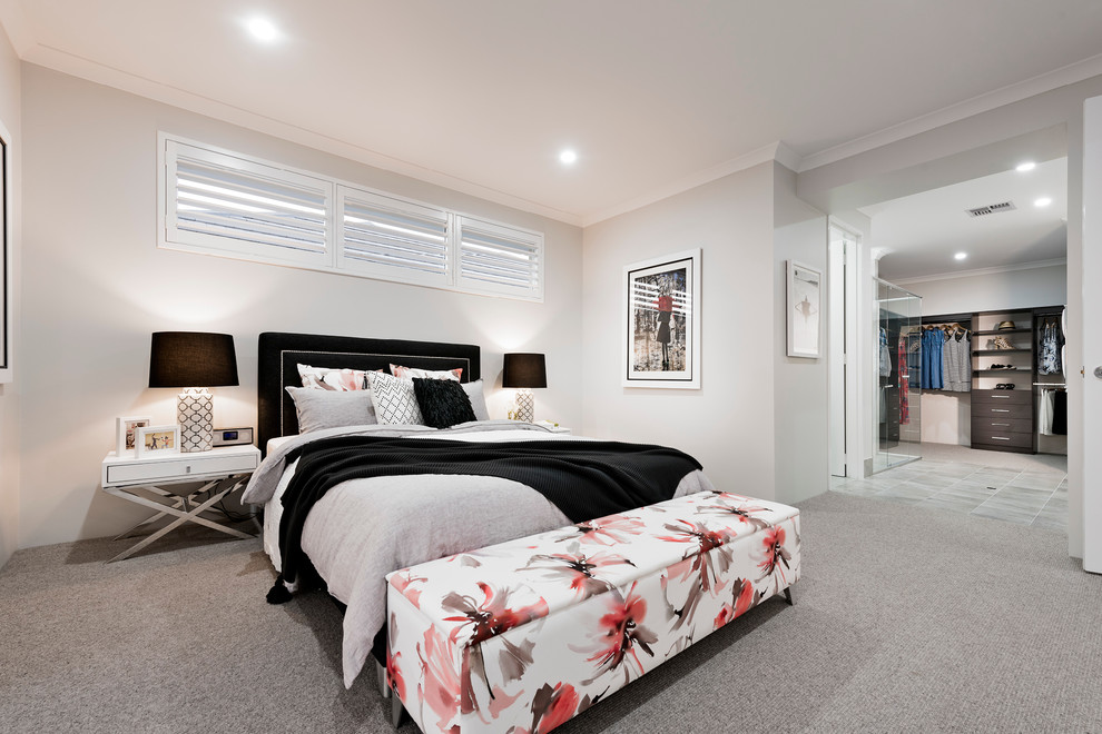 This is an example of a large contemporary master bedroom in Perth with beige walls and carpet.