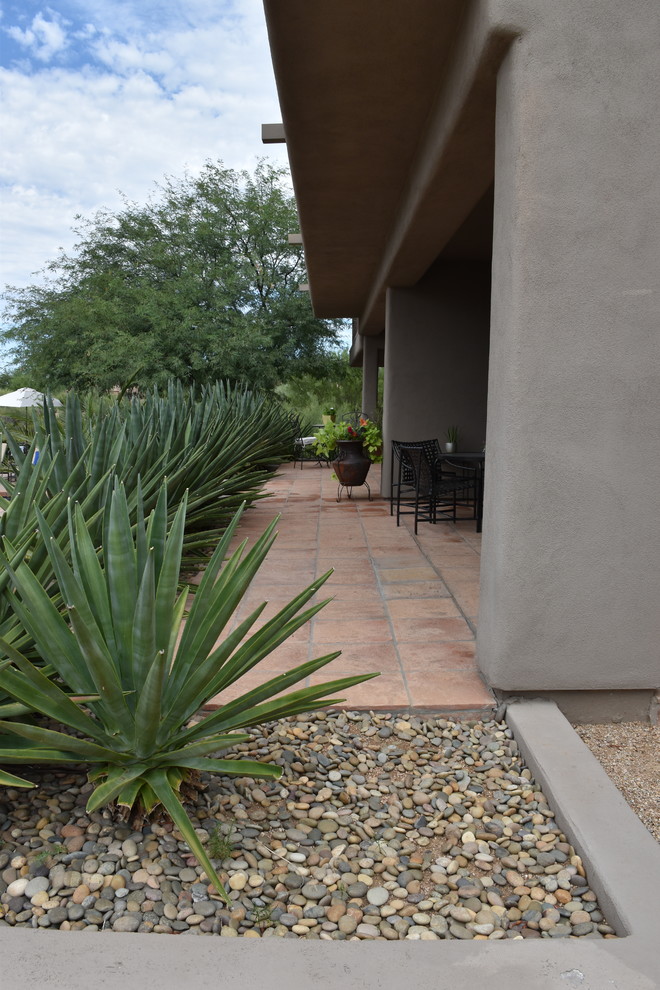 Photo of a large backyard patio in Phoenix with a fire feature, concrete slab and no cover.