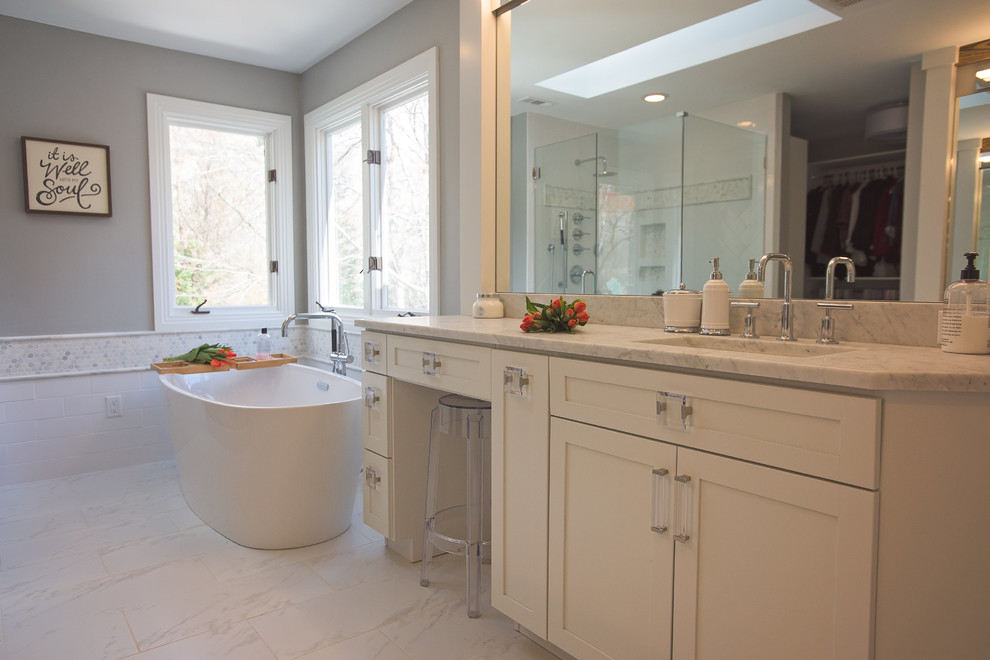 Inspiration for a large scandinavian master bathroom in Other with shaker cabinets, white cabinets, a freestanding tub, a corner shower, a two-piece toilet, white tile, marble, grey walls, porcelain floors, an undermount sink and marble benchtops.