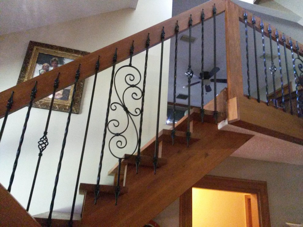 Inspiration for a mid-sized traditional wood l-shaped staircase in Jacksonville with open risers.