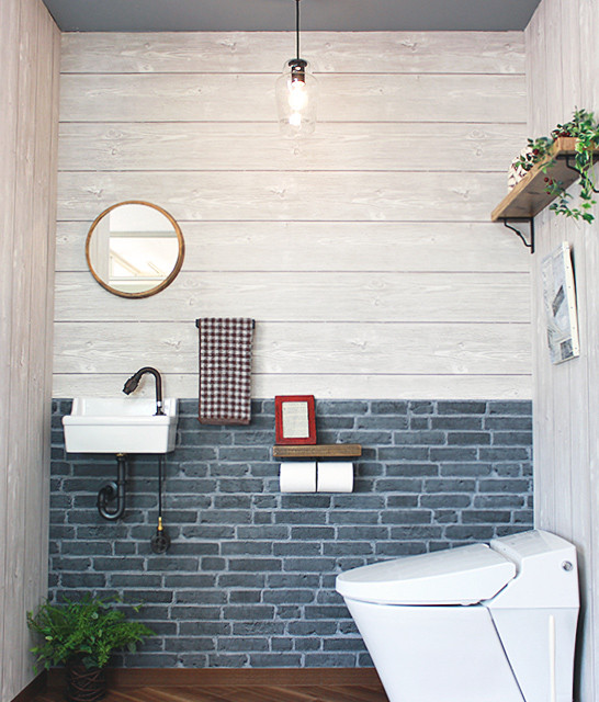 Design ideas for a small industrial powder room in Other with blue walls, plywood floors, a wall-mount sink, brown floor and white benchtops.