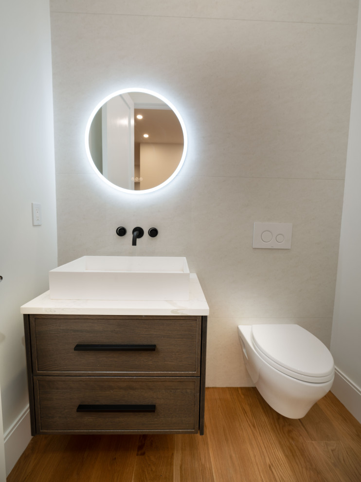 Example of a transitional powder room design in Boston with shaker cabinets, dark wood cabinets, a wall-mount toilet, a vessel sink, quartz countertops and a floating vanity