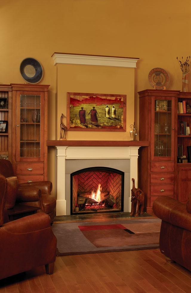 This is an example of a traditional living room in Denver with yellow walls, light hardwood floors, a standard fireplace and a concrete fireplace surround.