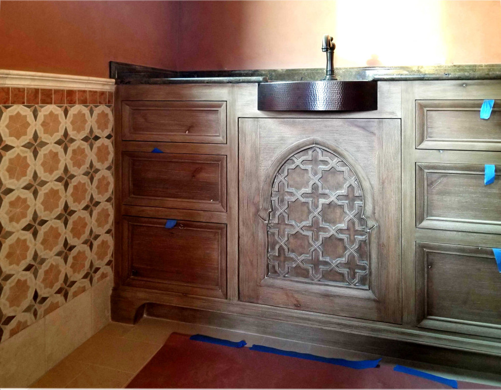This is an example of a mid-sized mediterranean 3/4 bathroom in Santa Barbara with recessed-panel cabinets, distressed cabinets, an alcove shower, orange tile, marble, white walls, marble floors, a vessel sink, marble benchtops, yellow floor, a hinged shower door, orange benchtops, a shower seat, a double vanity, a built-in vanity and decorative wall panelling.