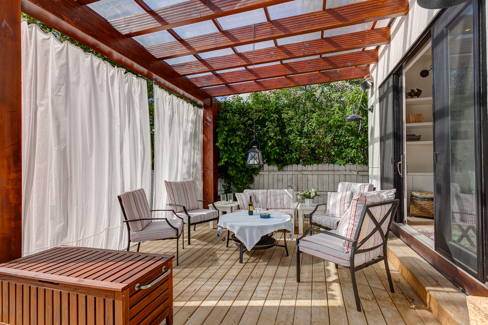 This is an example of a contemporary deck in Calgary with a pergola.