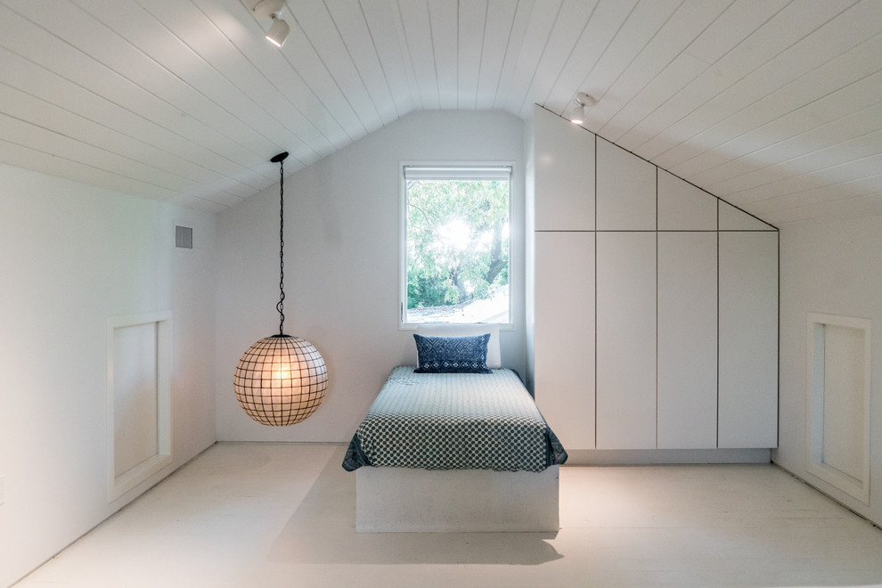 This is an example of a transitional guest bedroom in Austin with white walls, no fireplace and white floor.