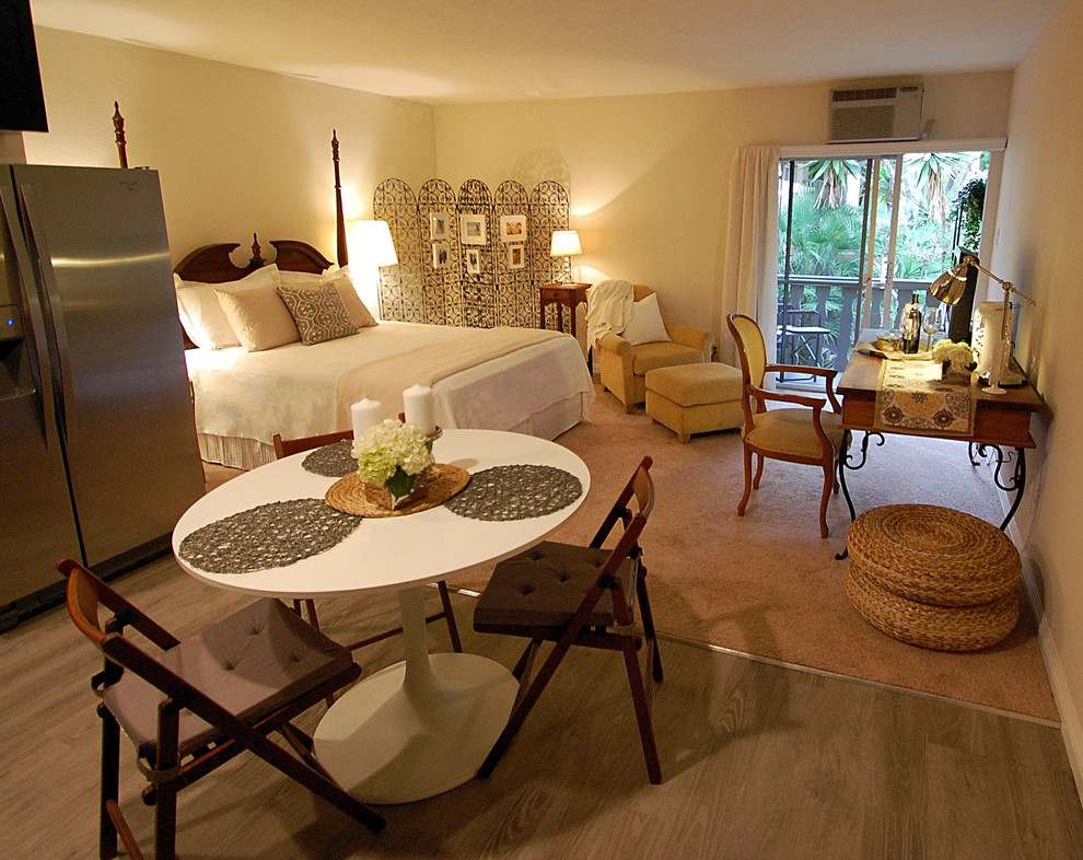 This is an example of a small eclectic master bedroom in Los Angeles with beige walls, carpet and no fireplace.
