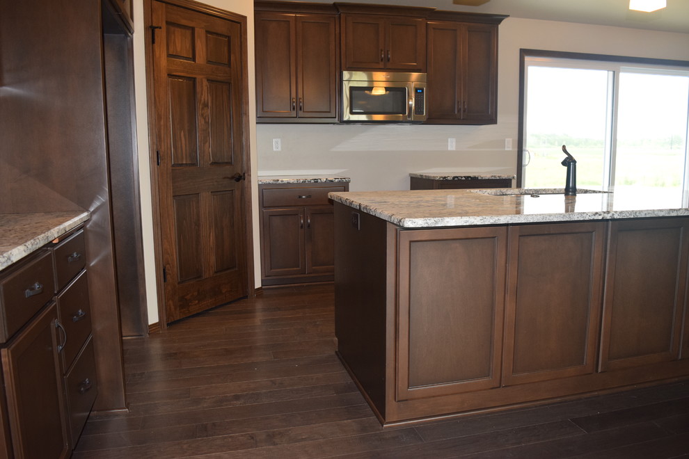 Inspiration for a rustic home design remodel with white cabinets, stainless steel appliances and an island