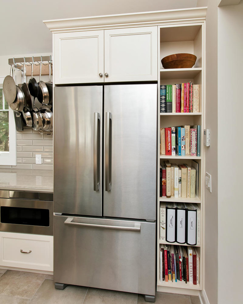 Eat-in kitchen - mid-sized transitional u-shaped porcelain tile eat-in kitchen idea in New York with an undermount sink, recessed-panel cabinets, white cabinets, wood countertops, gray backsplash, subway tile backsplash, stainless steel appliances and an island