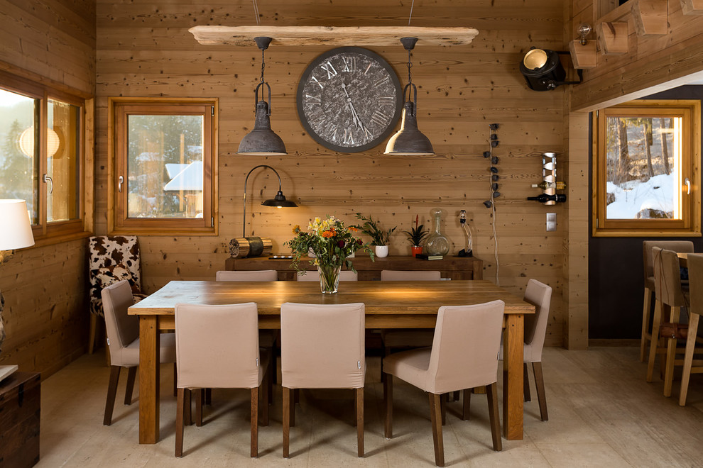 Design ideas for a mid-sized country open plan dining in Dijon with brown walls, light hardwood floors and no fireplace.