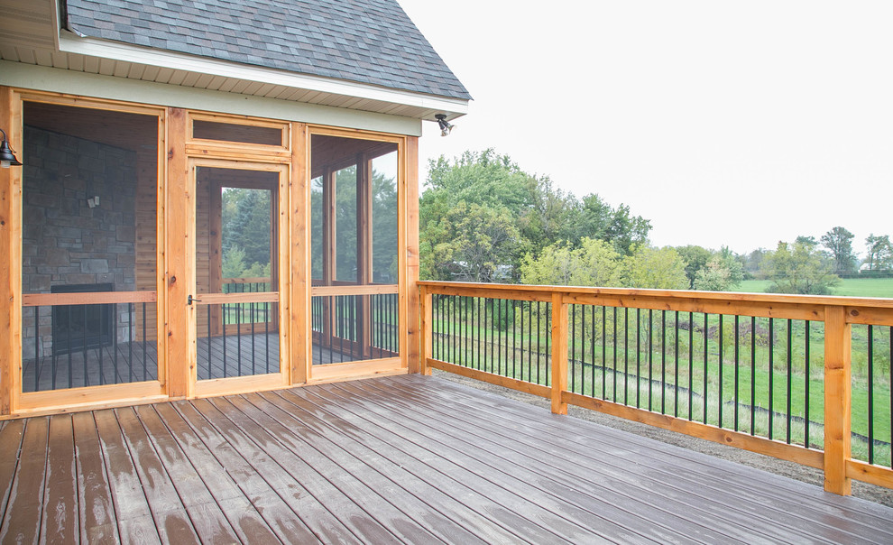 Transitional backyard deck photo in Minneapolis with a fire pit and a roof extension