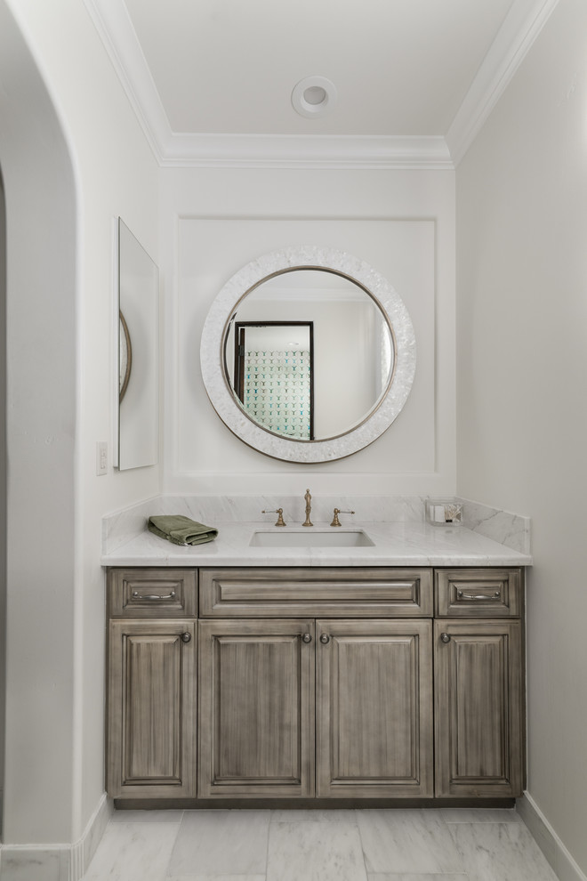 This is an example of an expansive traditional master bathroom in Phoenix with raised-panel cabinets, brown cabinets, a freestanding tub, an alcove shower, a two-piece toilet, multi-coloured tile, mirror tile, multi-coloured walls, porcelain floors, an undermount sink, marble benchtops, multi-coloured floor, a hinged shower door and multi-coloured benchtops.