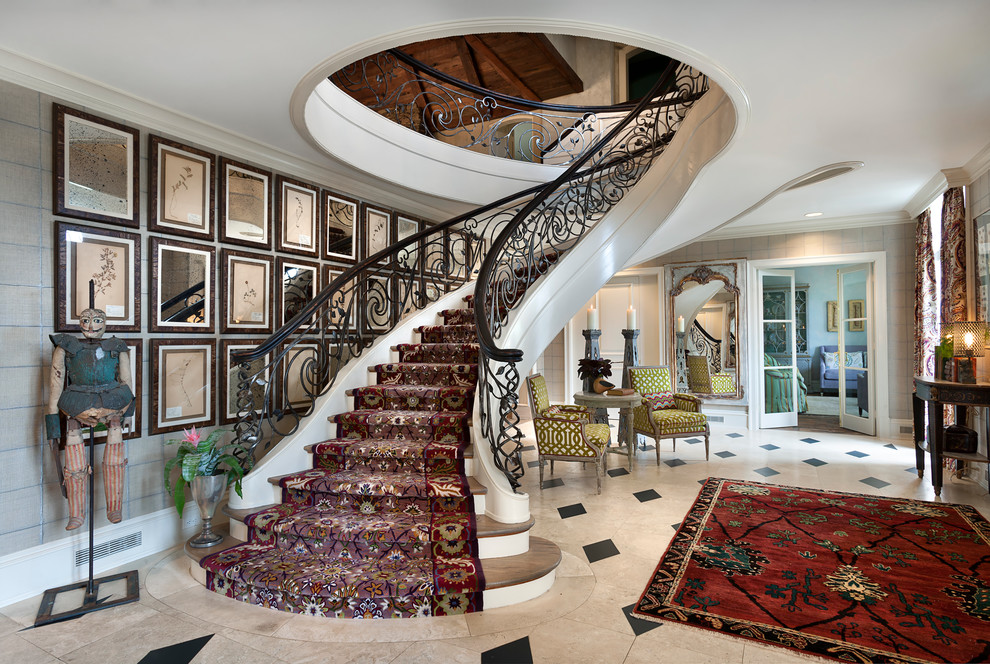 This is an example of an eclectic wood curved staircase in Charlotte with metal railing.