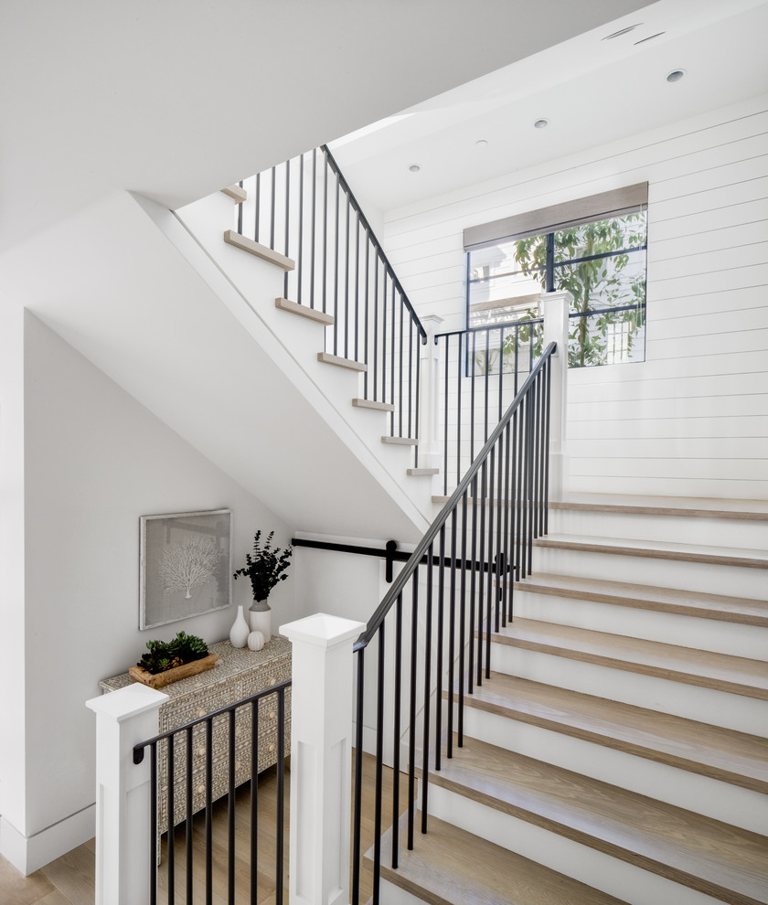 Staircase - coastal wooden u-shaped metal railing staircase idea in Orange County with painted risers
